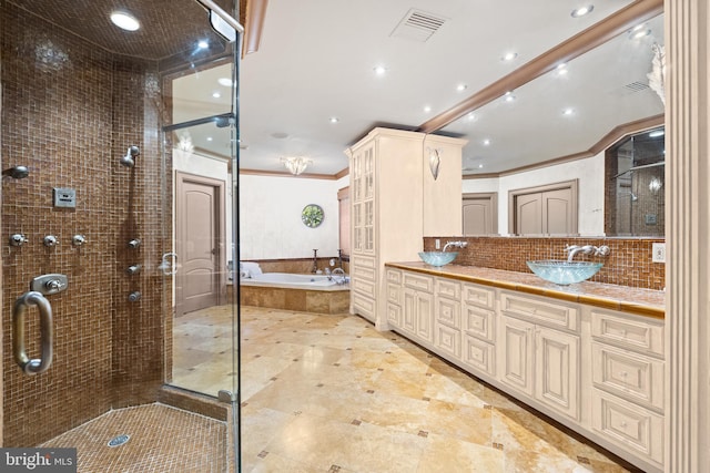 bathroom featuring ornamental molding, shower with separate bathtub, decorative backsplash, and vanity