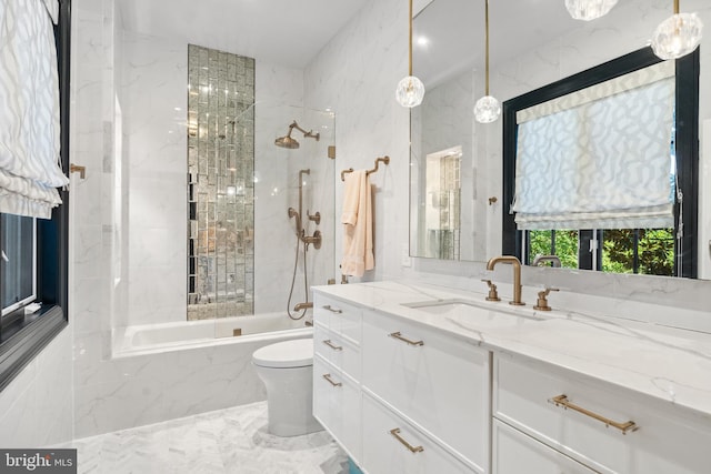 full bathroom featuring vanity, toilet, and tiled shower / bath