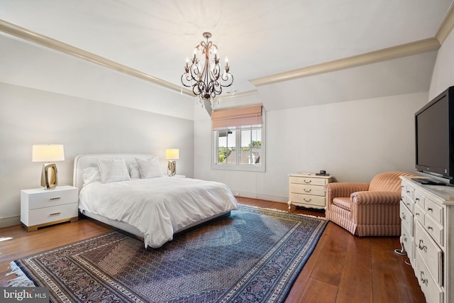 bedroom with dark wood-type flooring and a notable chandelier