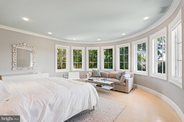 bedroom featuring crown molding and light hardwood / wood-style flooring