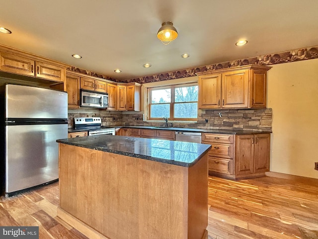 kitchen with light hardwood / wood-style flooring, a center island, and stainless steel appliances