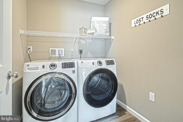 washroom with separate washer and dryer and dark hardwood / wood-style floors