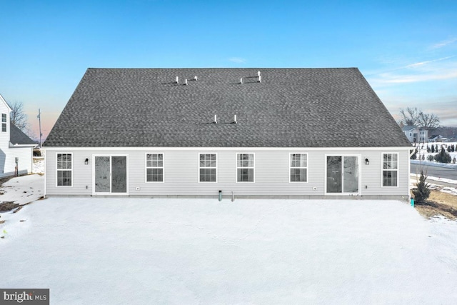 view of snow covered back of property