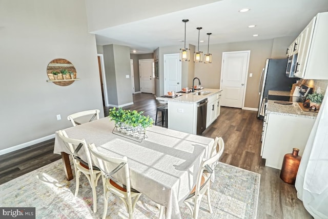 dining room with dark hardwood / wood-style flooring and sink