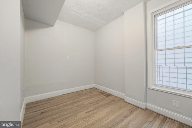 unfurnished room with light wood finished floors and baseboards