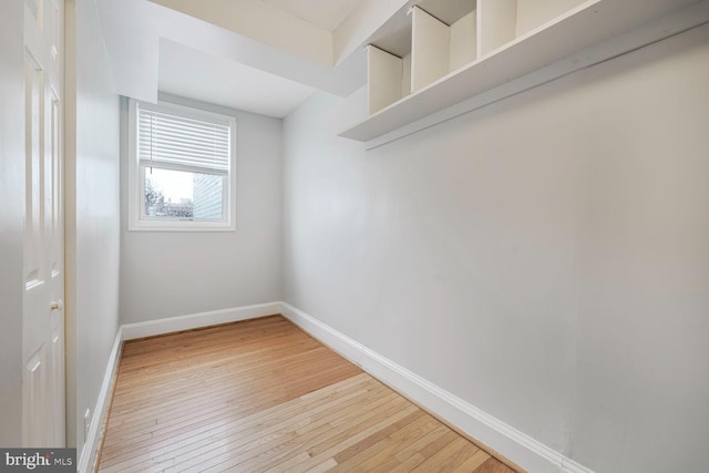 empty room with light wood-style flooring and baseboards