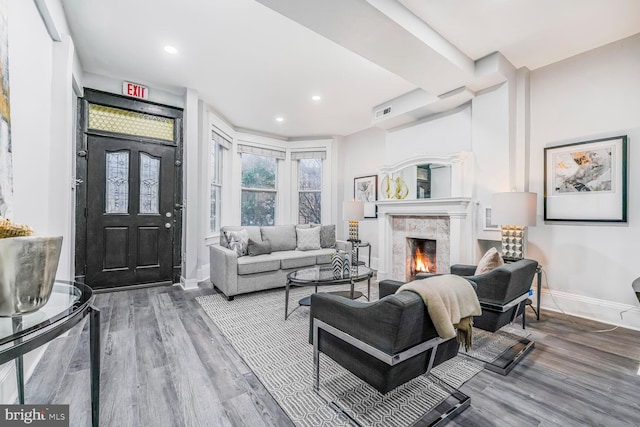 living area with visible vents, wood finished floors, recessed lighting, a fireplace, and baseboards