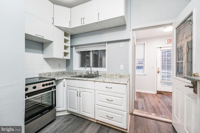 kitchen featuring dark wood-style floors, stainless steel range with electric cooktop, a sink, and white cabinetry