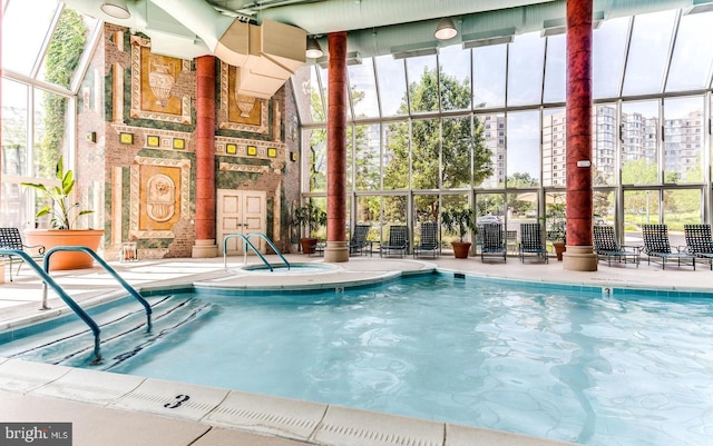 community pool with a view of city and a patio