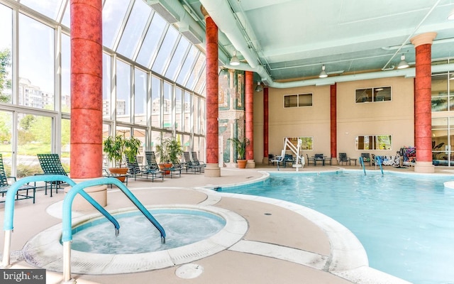 community pool with an indoor hot tub and a patio area