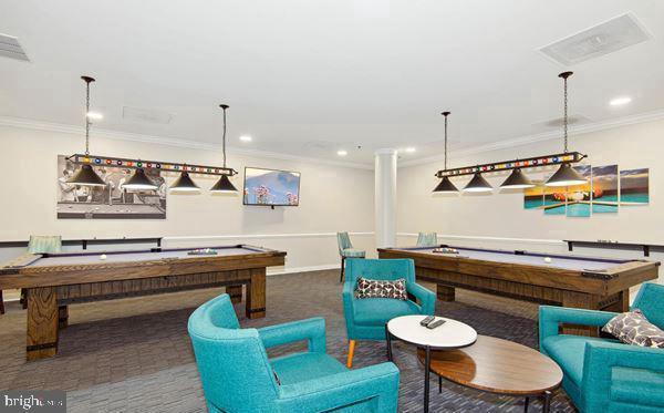 game room with dark carpet, ornamental molding, and pool table