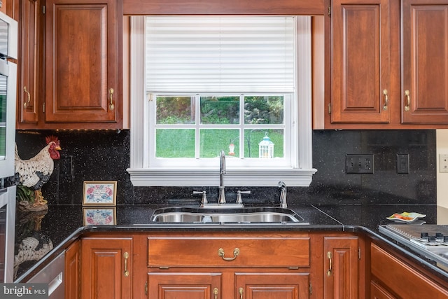 kitchen featuring decorative backsplash, stainless steel gas stovetop, and sink