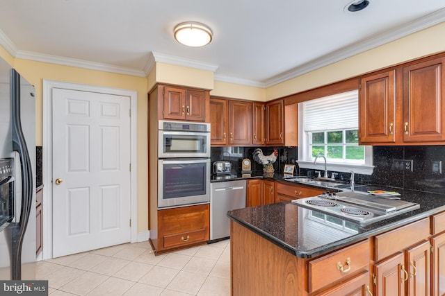 kitchen with sink, ornamental molding, and stainless steel appliances