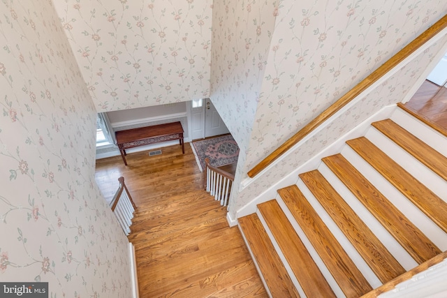 stairs featuring hardwood / wood-style floors