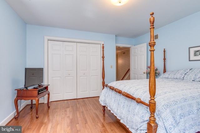 bedroom with a closet and hardwood / wood-style floors