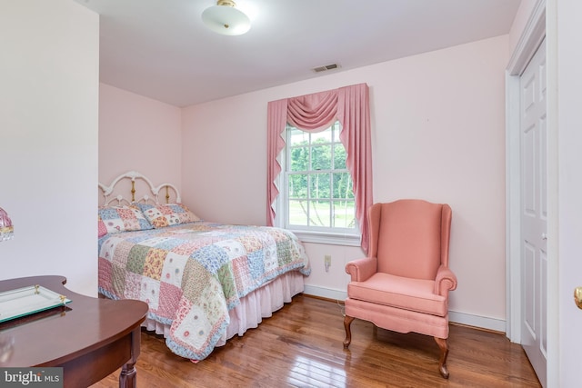 bedroom with hardwood / wood-style floors