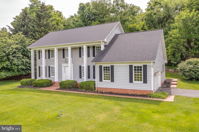 view of front facade with a garage and a front lawn