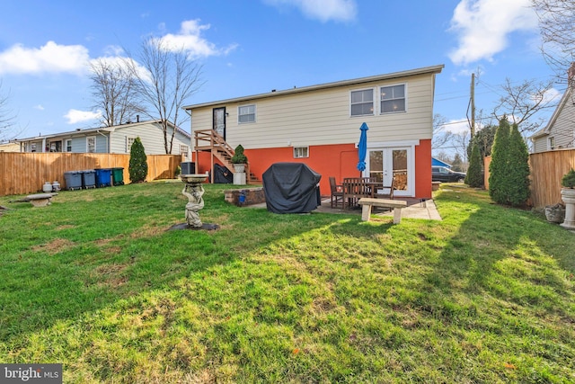 back of property featuring a yard, central AC unit, and a patio area