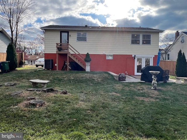 rear view of house with a yard