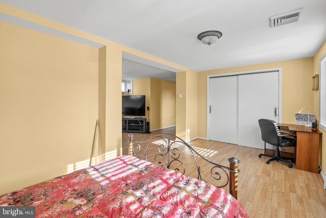 bedroom with a closet and light hardwood / wood-style flooring