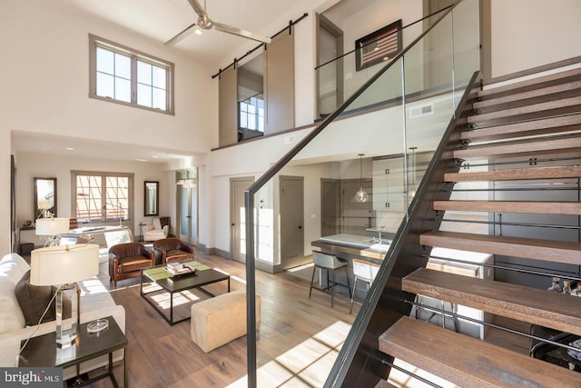 living room with hardwood / wood-style floors and a high ceiling