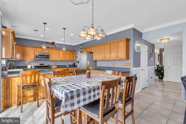 kitchen featuring hanging light fixtures, ornamental molding, appliances with stainless steel finishes, a notable chandelier, and light tile patterned flooring