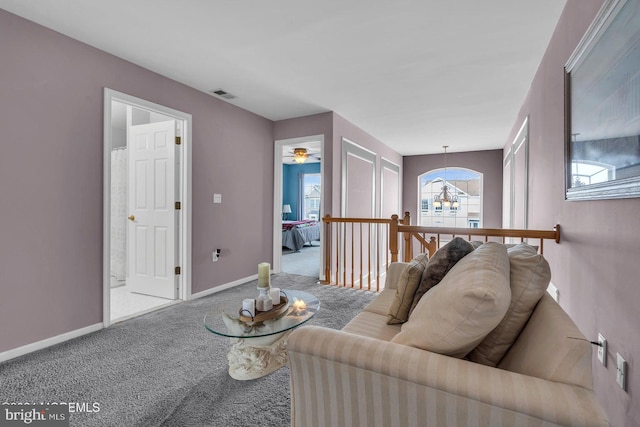 living room featuring a notable chandelier and carpet floors