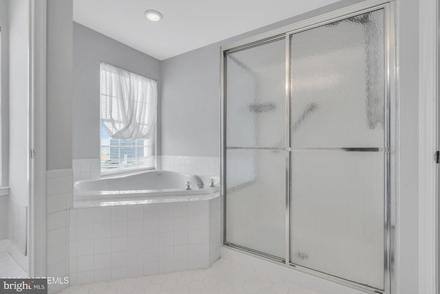 bathroom with tile patterned floors and shower with separate bathtub