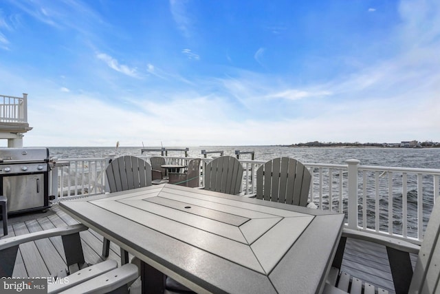 wooden terrace featuring a water view and grilling area