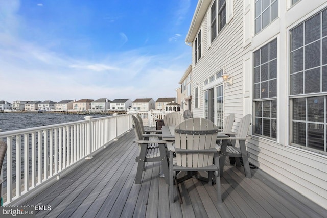 wooden terrace featuring a water view