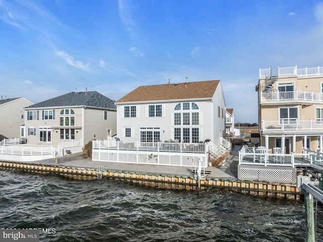 back of house featuring a water view