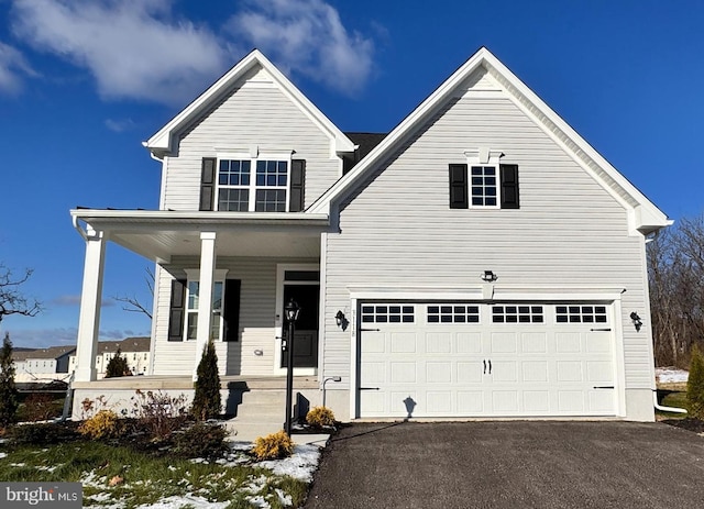 view of front of house with a porch and a garage