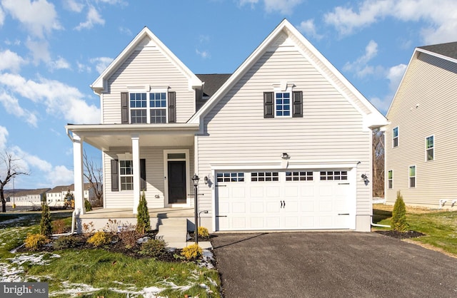 view of front of house featuring covered porch and a garage