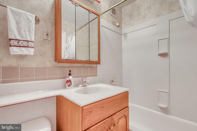 bathroom with vanity and shower / washtub combination