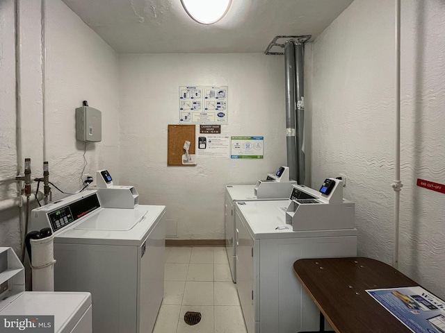 washroom featuring washer and clothes dryer and light tile patterned floors