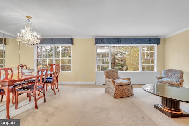 carpeted dining room featuring a chandelier and crown molding