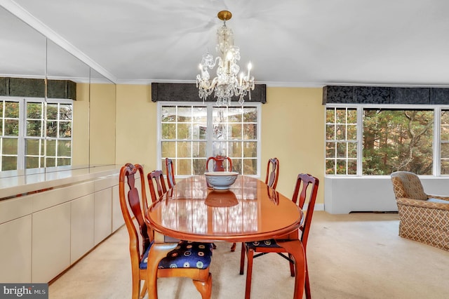 carpeted dining area featuring an inviting chandelier and crown molding