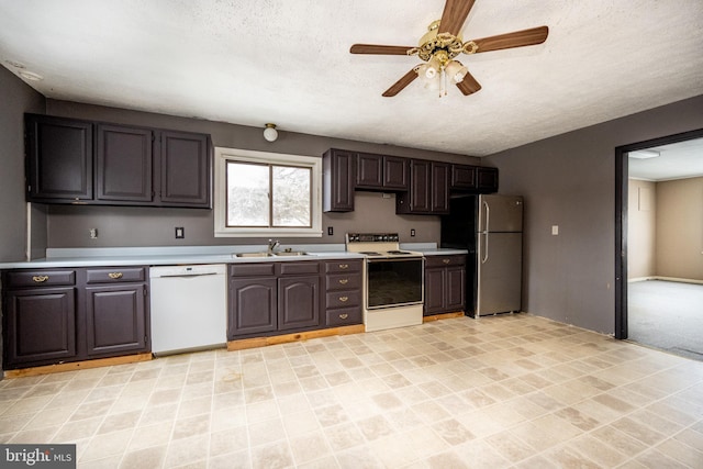 kitchen with a textured ceiling, white appliances, dark brown cabinets, and ceiling fan