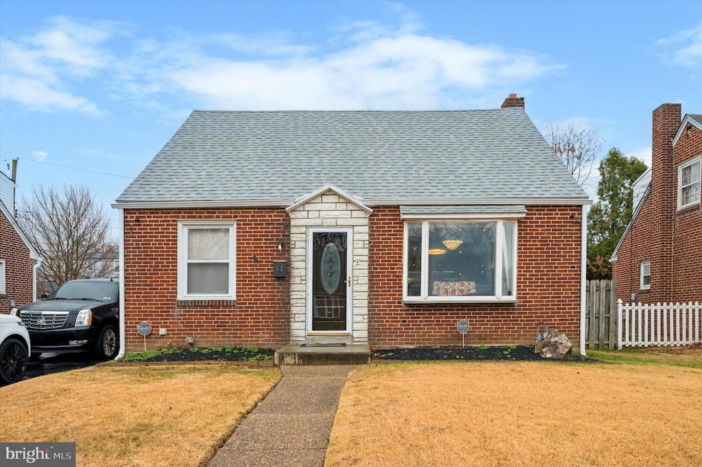 bungalow-style home featuring a front yard