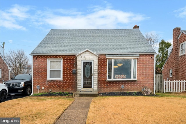 bungalow-style home featuring a front yard