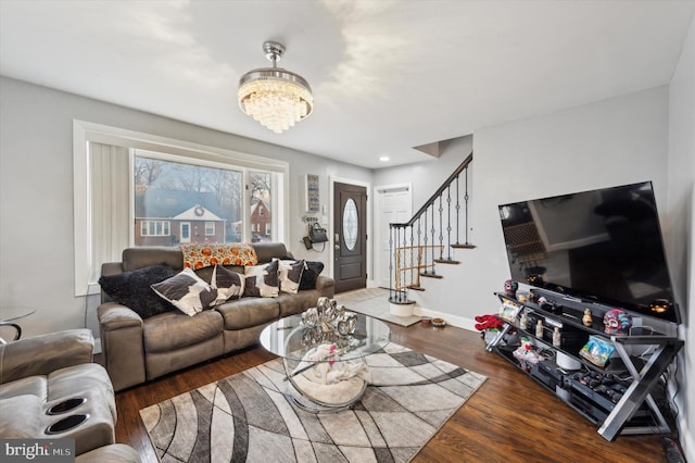 living room featuring dark hardwood / wood-style flooring and a notable chandelier