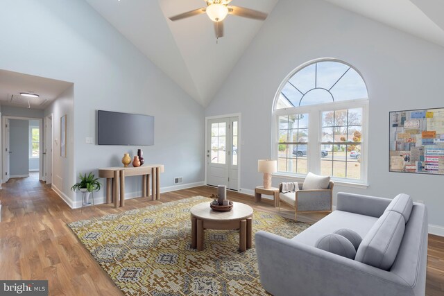 living room with ceiling fan, high vaulted ceiling, and hardwood / wood-style flooring