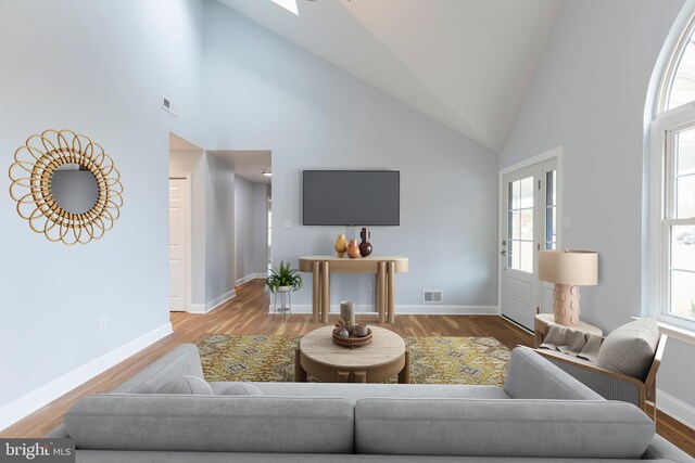 living room with hardwood / wood-style flooring and high vaulted ceiling