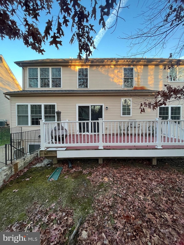 rear view of house featuring a wooden deck