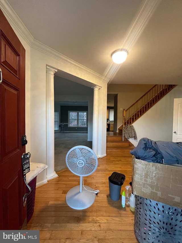 interior space featuring light wood-type flooring and crown molding