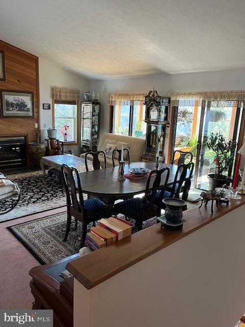 dining area with a textured ceiling and vaulted ceiling