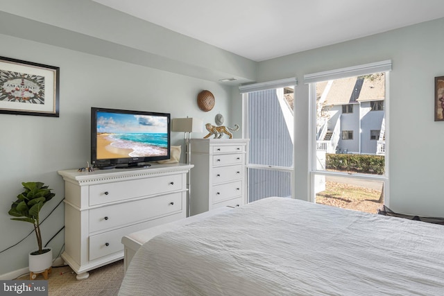 bedroom featuring light colored carpet