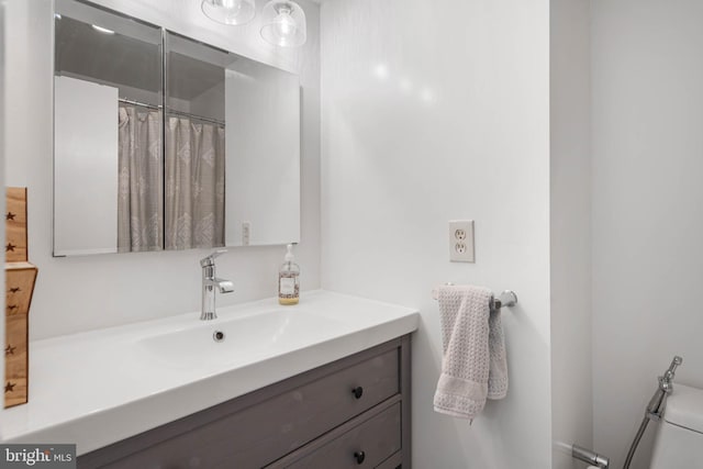 bathroom with vanity and toilet