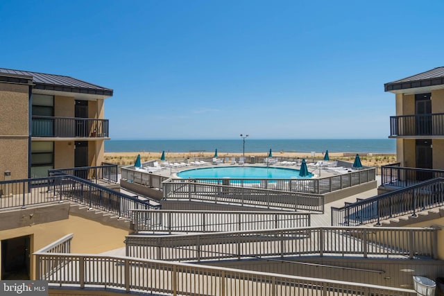 view of pool featuring a water view