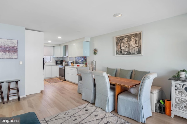 dining space with light wood-type flooring